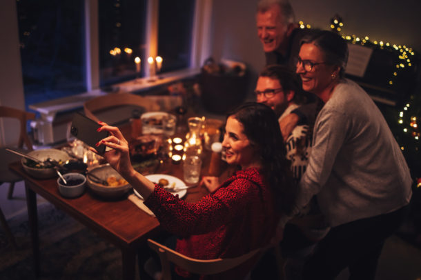 Family having a video call during Christmas dinner