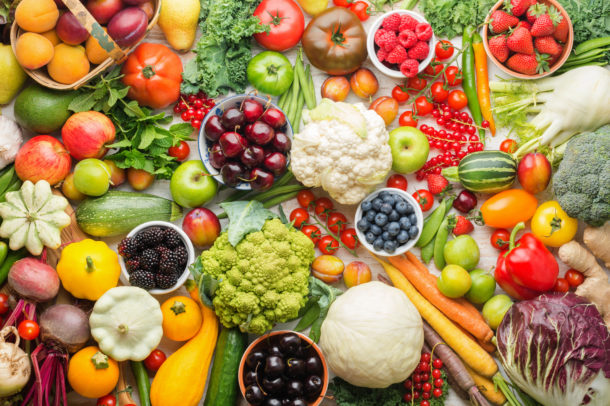 Healthy summer fruits vegetables berries background, cherries peaches strawberries cabbage broccoli cauliflower squash tomatoes carrots spring onions beans beetroot, pepper, top view, selective focus