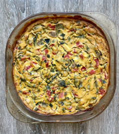 a pie plate holding a vegetable and tofu frittata