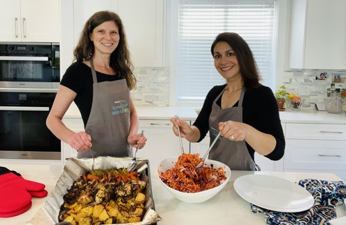 Two women in a kitchen cooking together